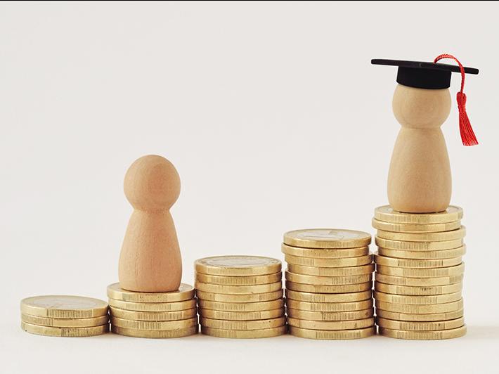 Wooden figures progressing across stacks of coins toward education